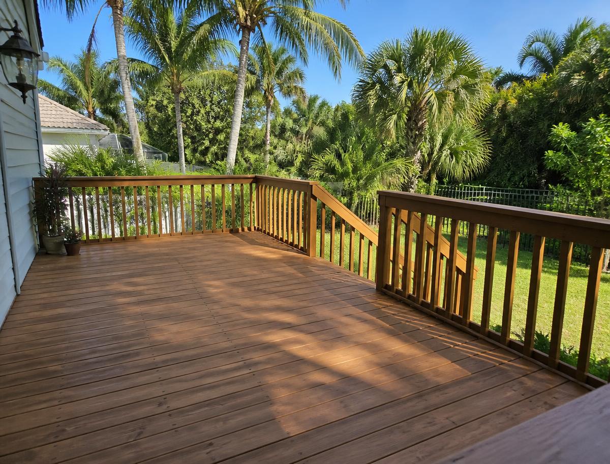 Repaired and refinished wood deck with solid railing after deck repair