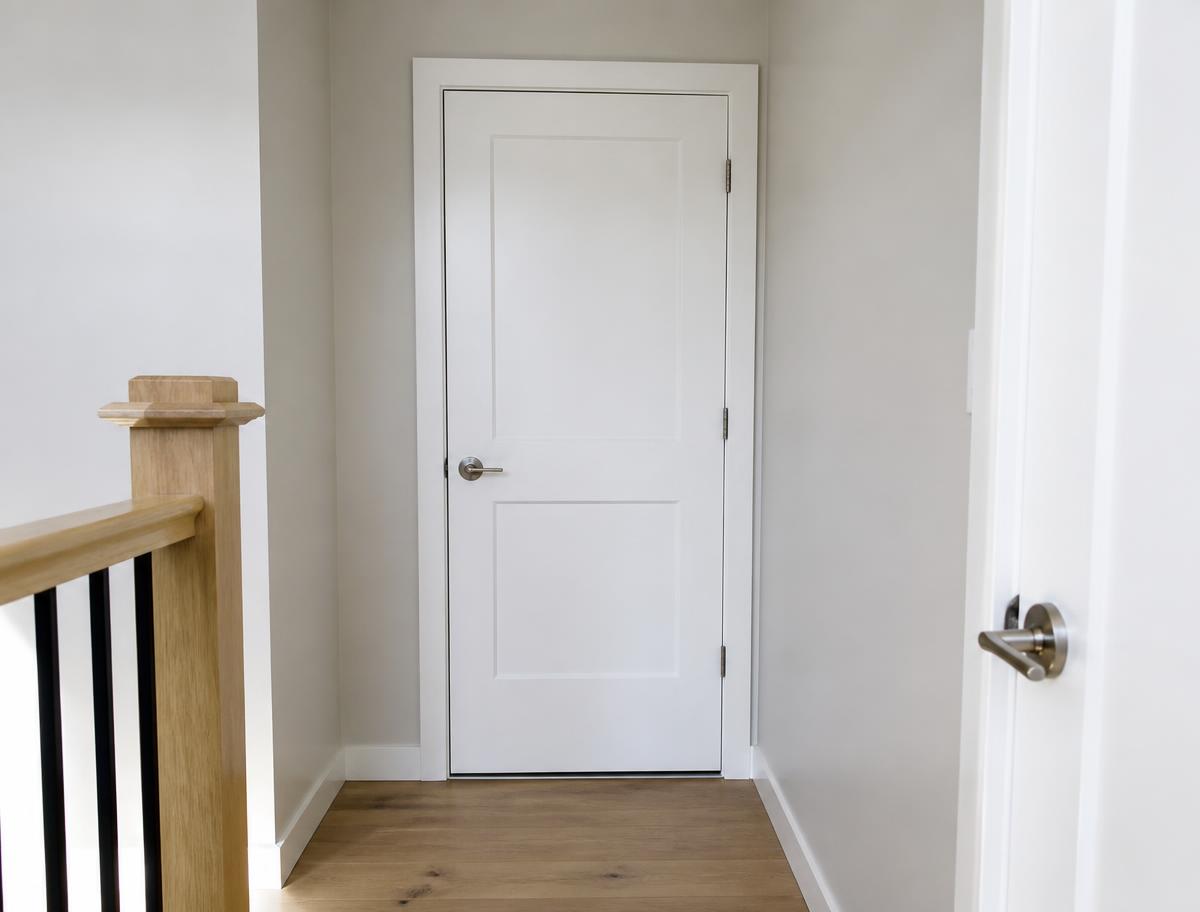 Properly hung interior door with even gaps and new handle after repair